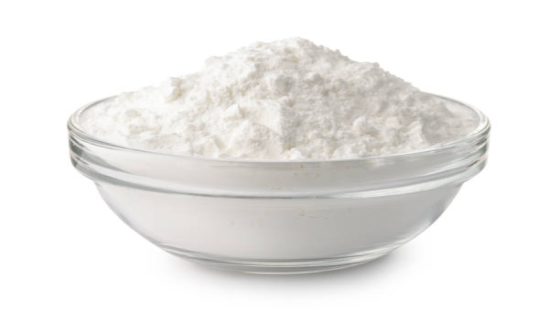 Glass bowl of corn starch isolated on white