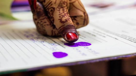 lady giving thumb impression on marriage registry certificate. Indian matrimony. Bengali weddding